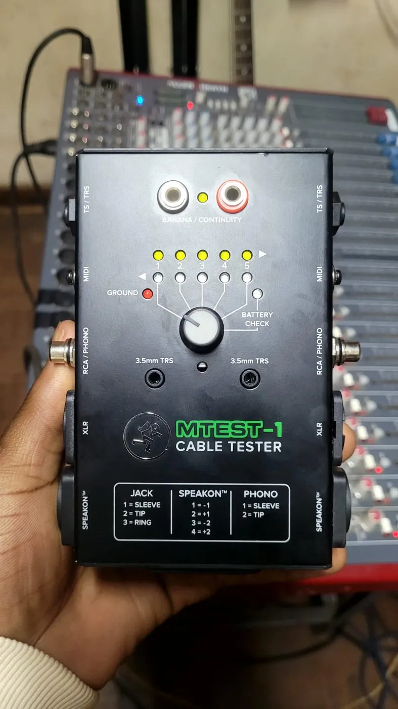 Cable tester being used in front of a mixing desk
