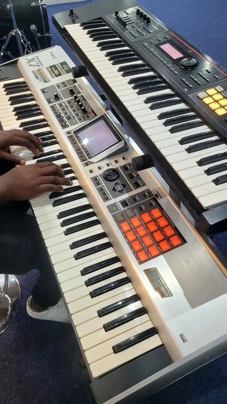 Two keyboards set up for a live performance