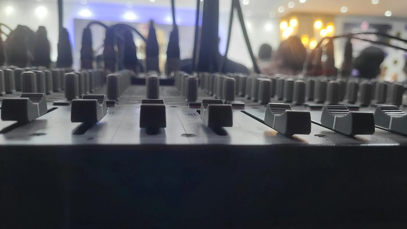 Close view of mixer faders at a live event